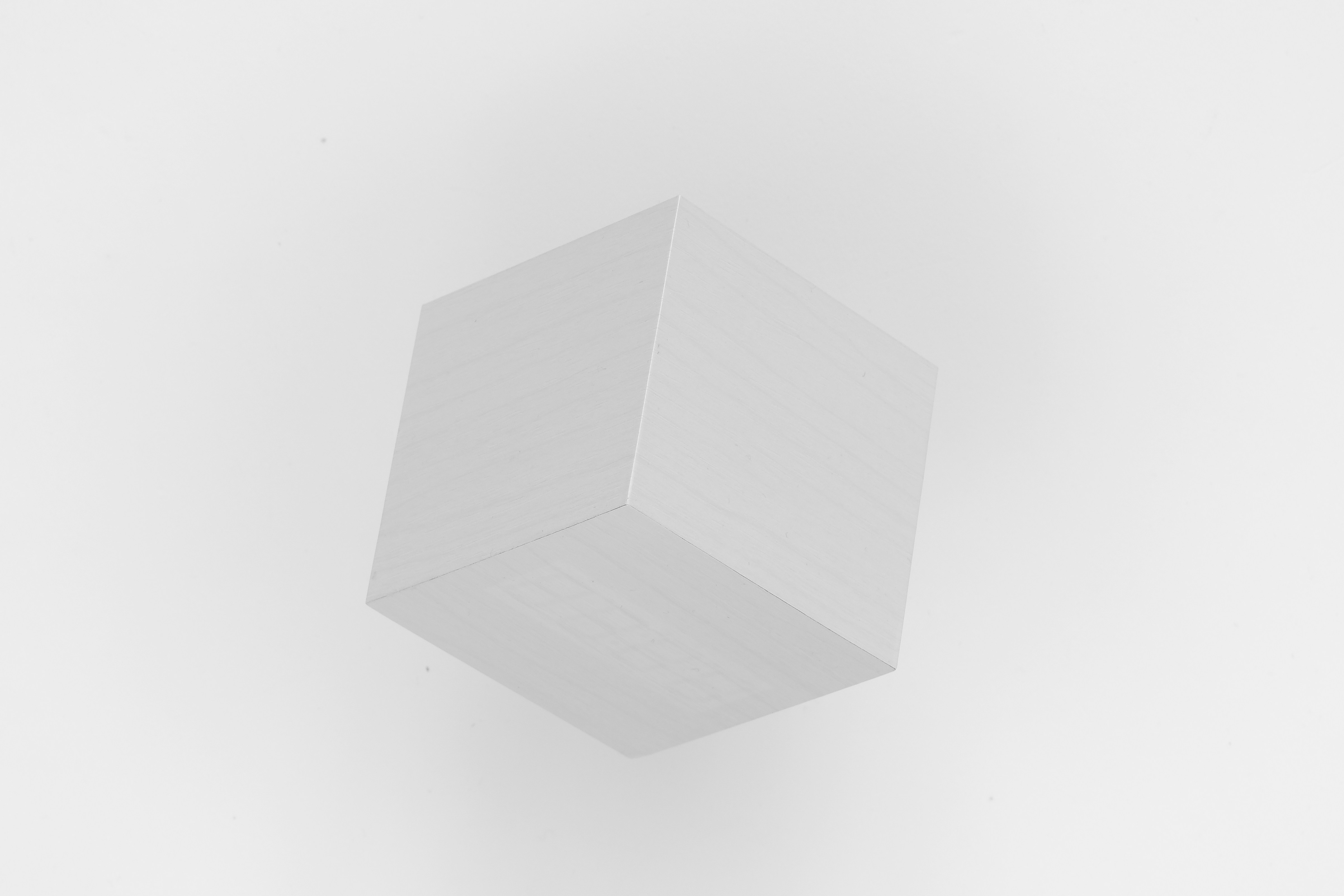 A white cube photographed on a white background, the White Box mark
